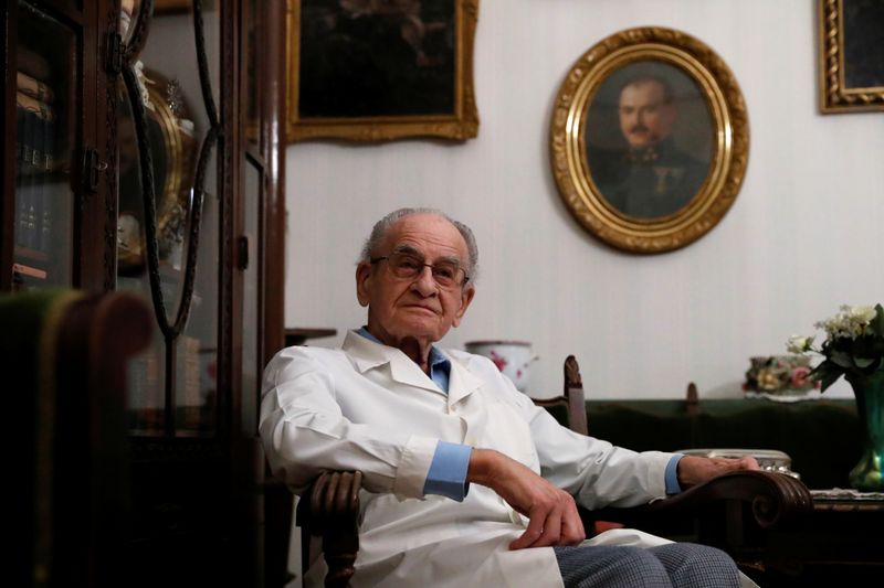 Kormendi, 97-year-old doctor, poses for a picture in his doctor’s