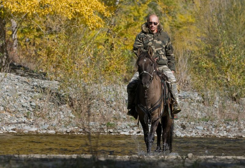 FILE PHOTO: Russia’s Prime Minister Putin rides a horse as