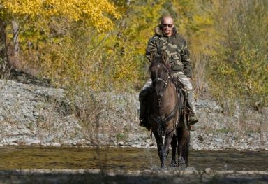 FILE PHOTO: Russia’s Prime Minister Putin rides a horse as