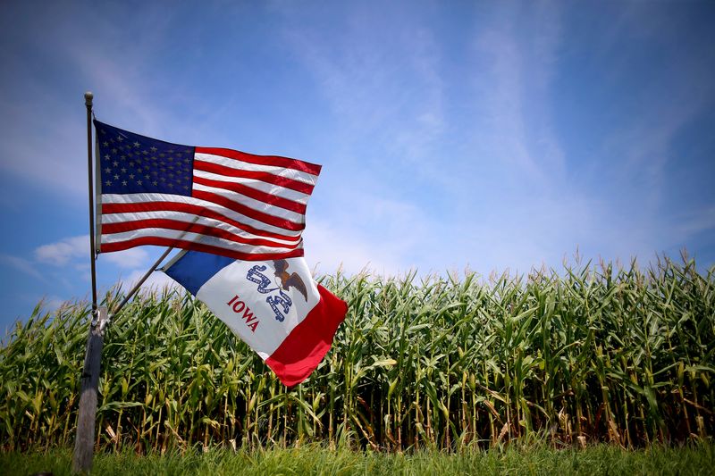 FILE PHOTO: A U.S. and Iowa state flag are seen