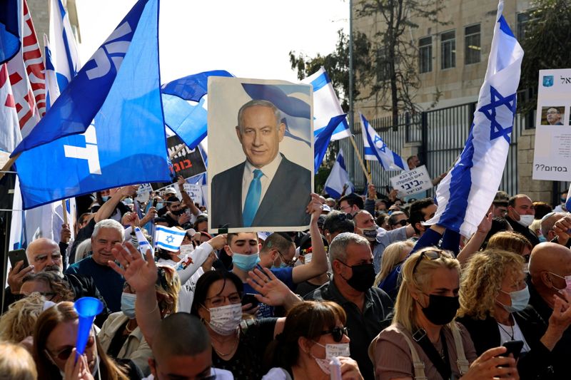 Supporters of Israeli Prime Minister Benjamin Netanyahu, wave flags and