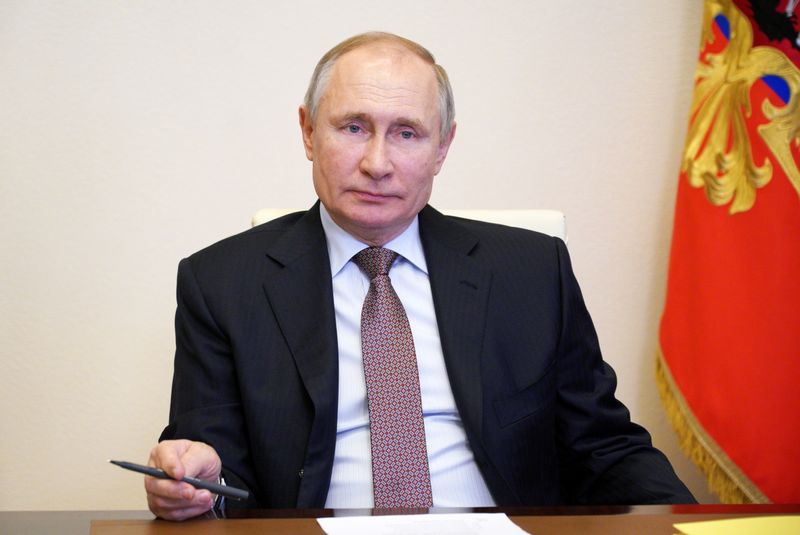 Russian President Vladimir Putin takes part in the signing ceremony