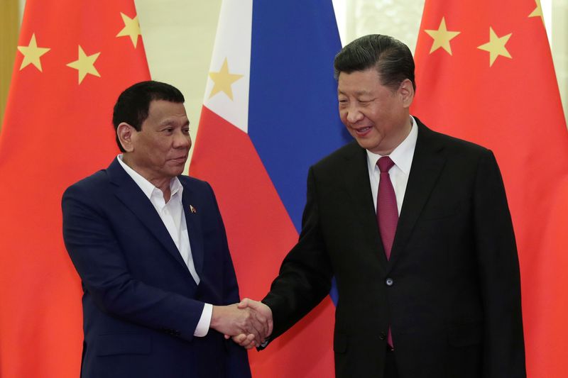 FILE PHOTO: Philippine President Rodrigo Duterte shakes hands with Chinese