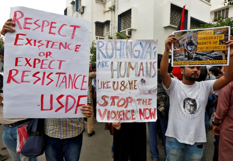 FILE PHOTO: People hold placards during a protest rally against