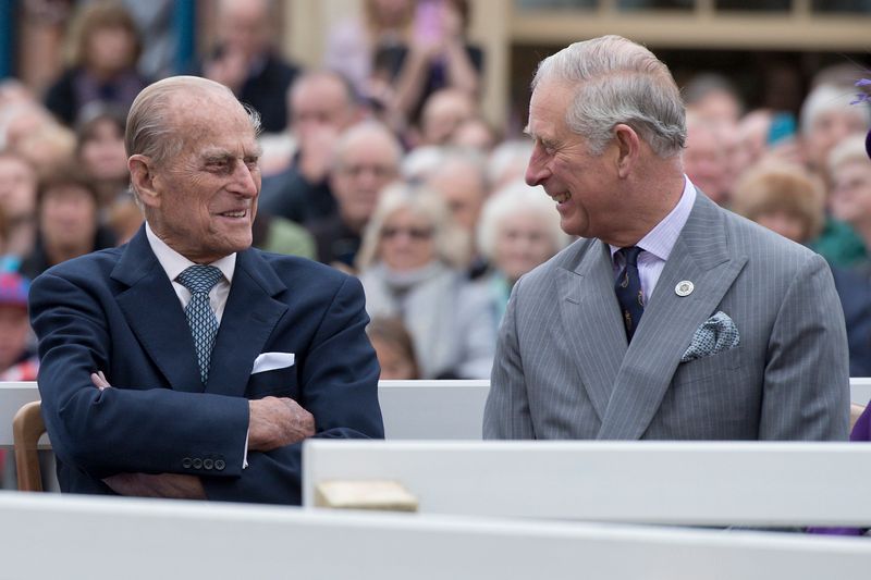 Britain’s Prince Philip and Prince Charles listen to speeches before