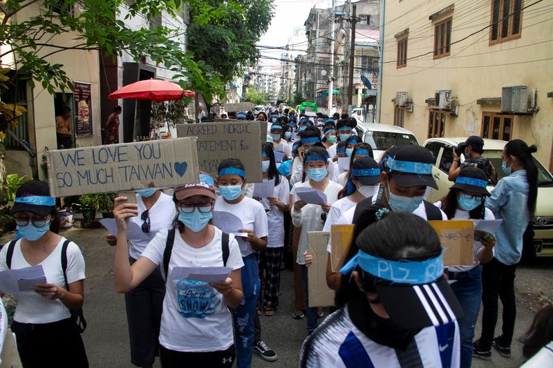 Demonstrators march during a protest against military coup in Yangon