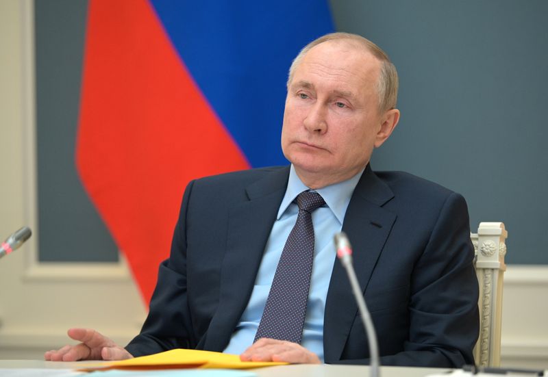 Russian President Putin attends a session of the Russian Geographical
