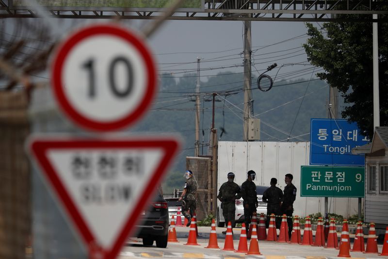 FILE PHOTO: Soldiers stand guard at a checkpoint on the