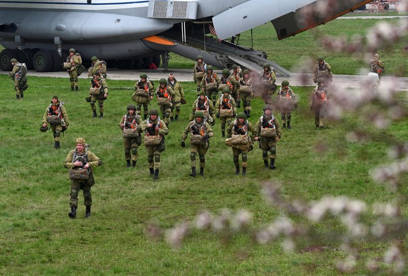Russian paratroopers take part in drills at a military aerodrome