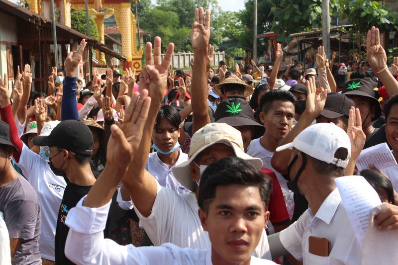People attend a protest against Myanmar’s military coup in Launglon