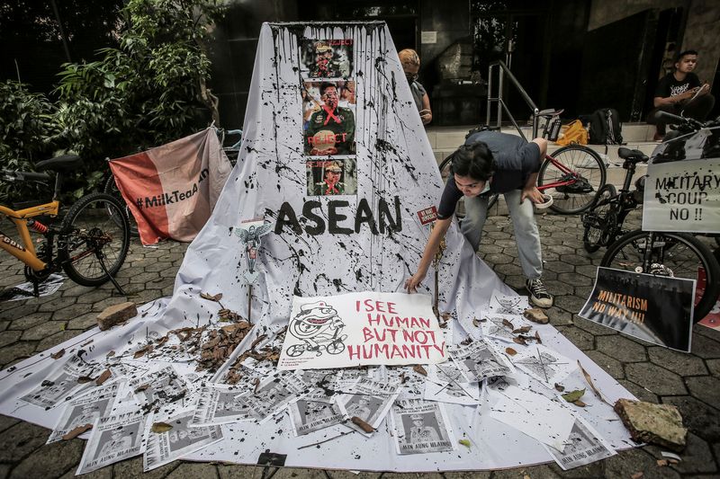 FILE PHOTO: A woman prepares a placard out of crossed