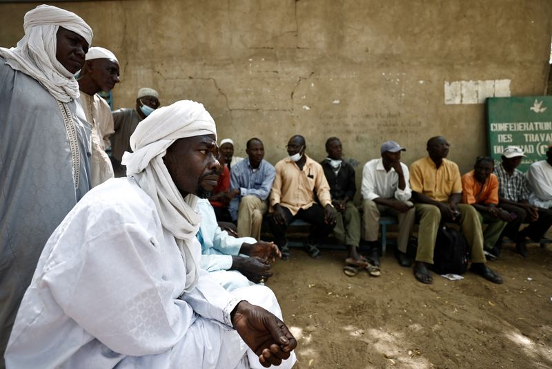 Men sit in shade outside CLTT office in N’djamena