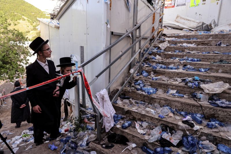 Ultra Orthodox Jews look at stairs with waste on it