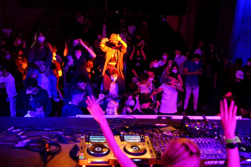 Clubbers hit dance floor again as Spain trials digital COVID-19