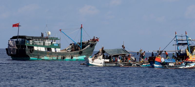 FILE PHOTO: A Chinese fishing vessel is anchored next to