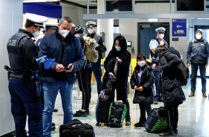 FILE PHOTO: Federal police officers check flight passengers arriving from