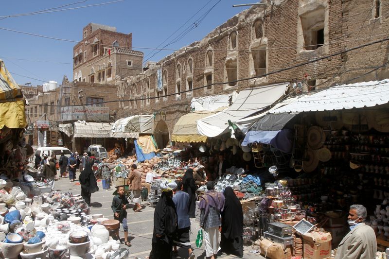 FILE PHOTO: People shop at a market in the old