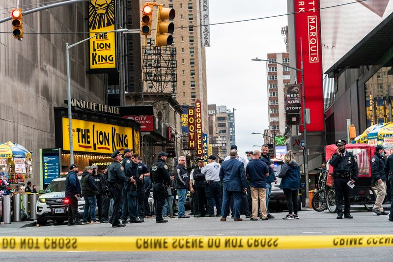 New York City police officers stand guard after a shooting
