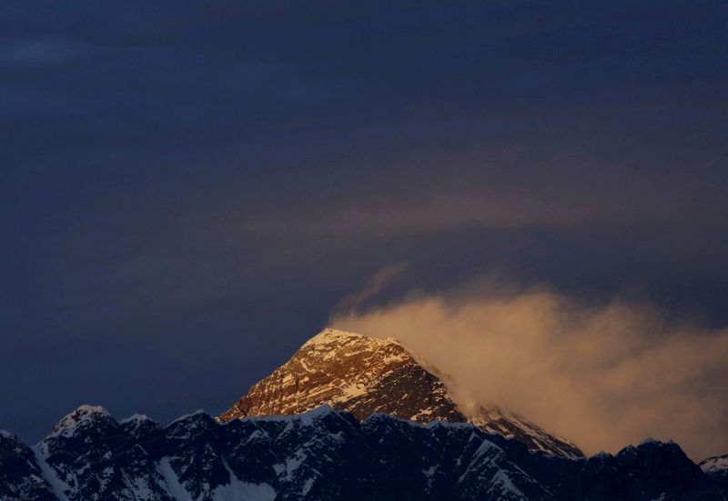 FILE PHOTO: FILE PHOTO: Light illuminates Mount Everest, during sunset