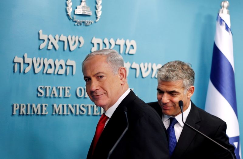 FILE PHOTO: Israeli Prime Minister Netanyahu and Finance Minister Lapid