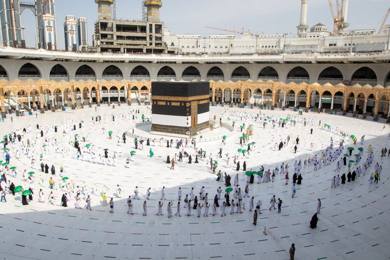 Pilgrims keeping social distance perform their Umrah in the Grand