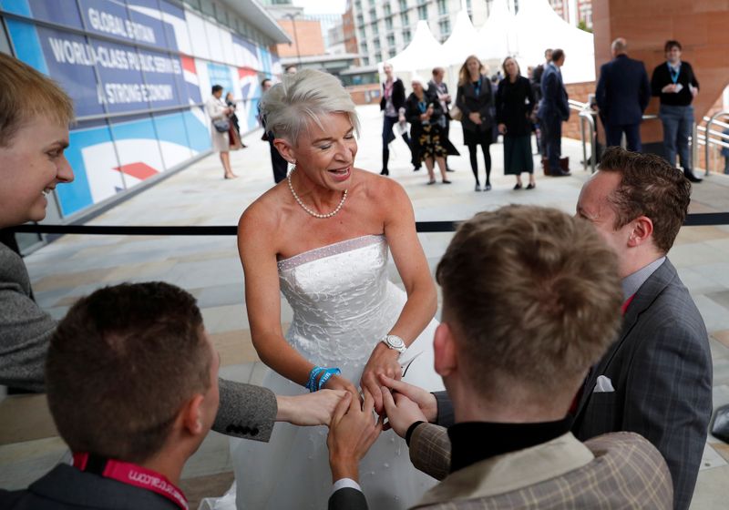 Newspaper columnist Katie Hopkins arrives dressed in a wedding dress