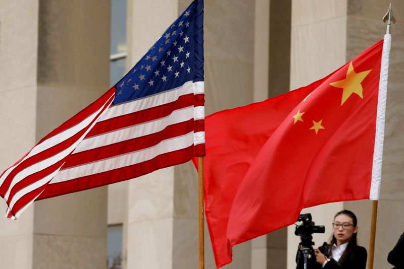 FILE PHOTO: U.S. and Chinese flags outside the Pentagon