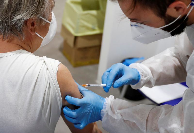 FILE PHOTO: Italians receive Moderna COVID-19 vaccine, in Rome