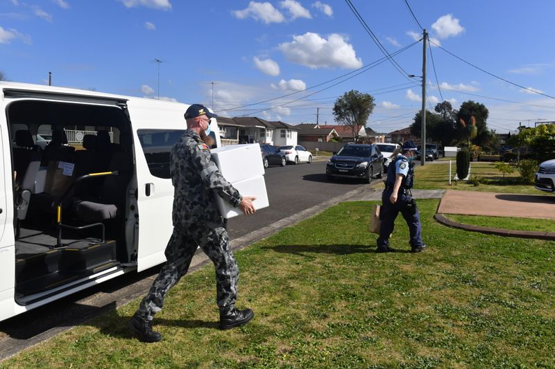 Defence Force personnel and NSW police deliver food to people