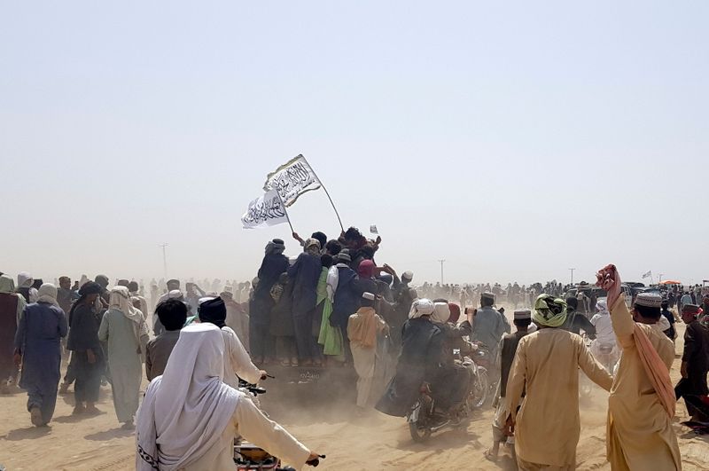 People on vehicles gather near Friendship Gate crossing on Pakistan-Afghanistan