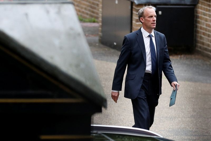 Britain’s Foreign Secretary Raab walks outside the Foreign, Commonwealth and