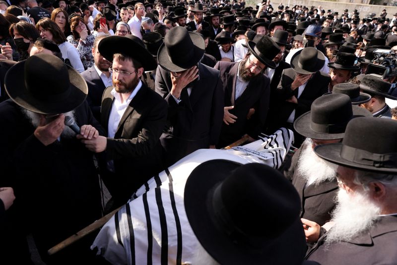FILE PHOTO: Ultra-Orthodox Jewish men take part in a funeral