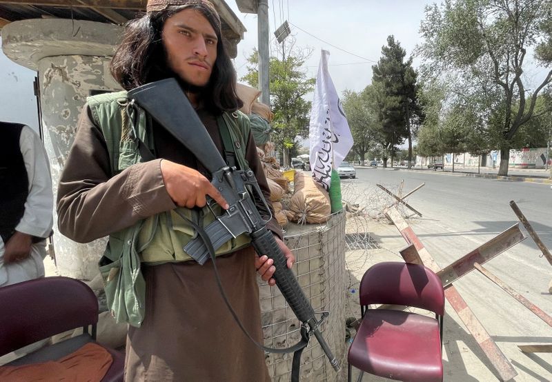 A member of Taliban forces keeps watch at a checkpost