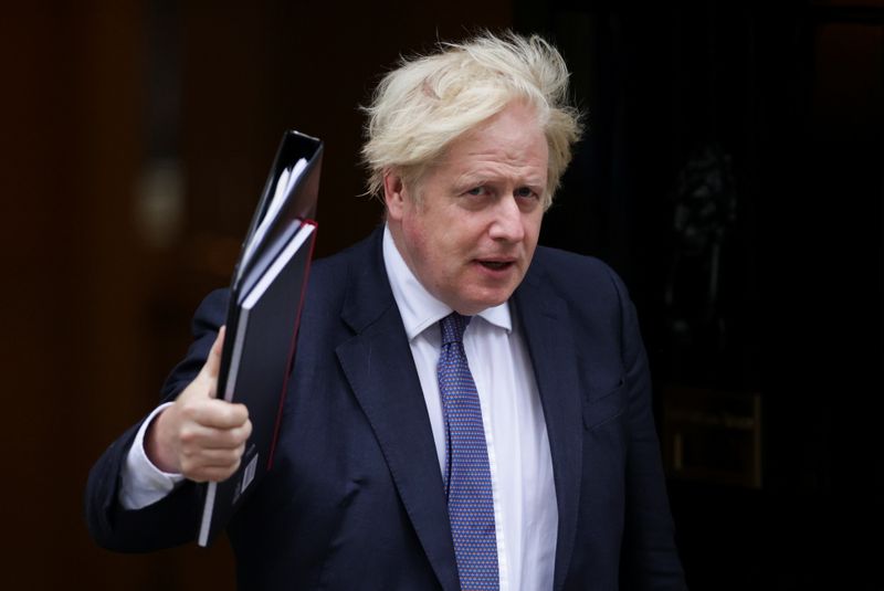 Britain’s PM Boris Johnson walks outside Downing Street in London