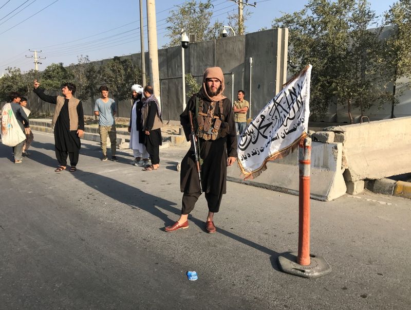 A member of Taliban stands outside the Interior Ministry in