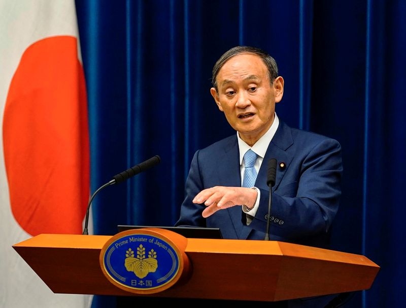 FILE PHOTO: Japanese Prime Minister Yoshihide Suga speaks during a