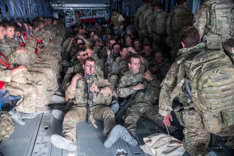 UK military personnel are seen onboard an A400M aircraft departing