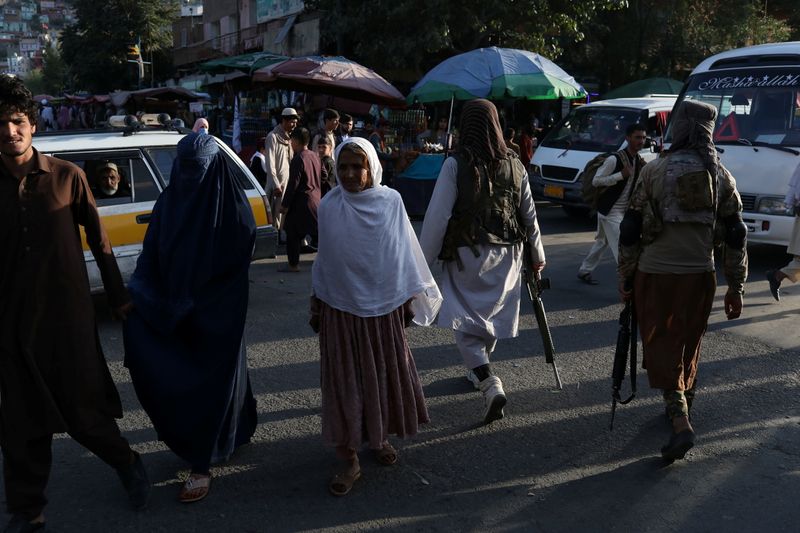 Two Taliban soldiers patrol the city center of Kabul