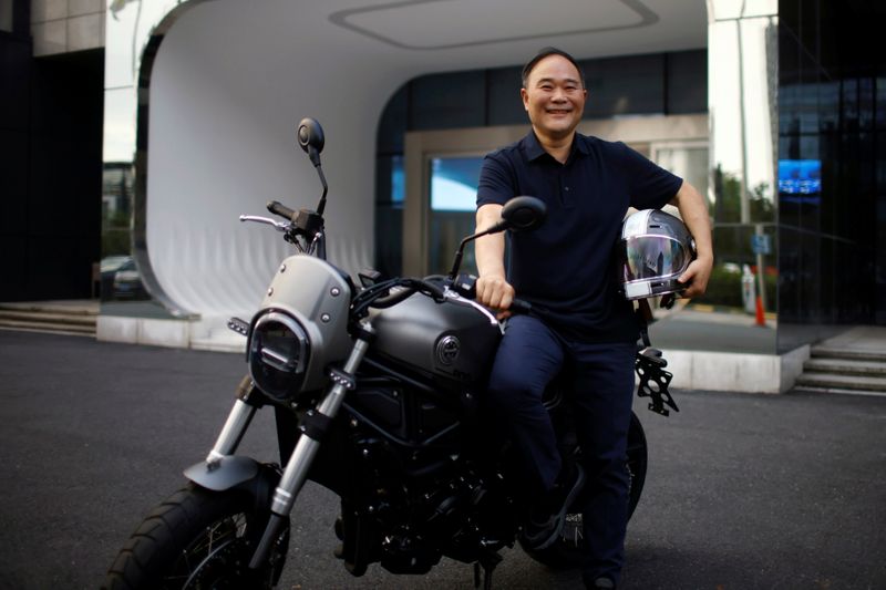 Zhejiang Geely Holding Group’s Chairman Li Shufu poses for pictures