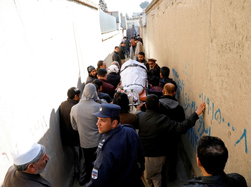 FILE PHOTO: Relatives carry the body of female judge shot