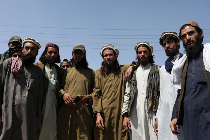Taliban members pose for a photograph in Kabul