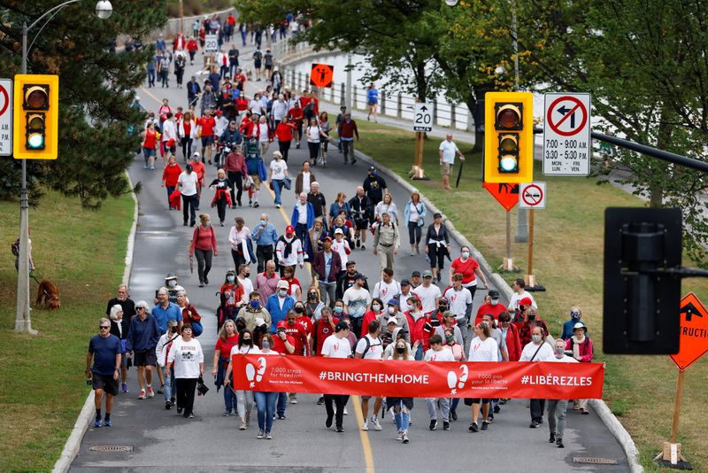 Supporters of Michael Kovrig and Michael Spavor march in Ottawa