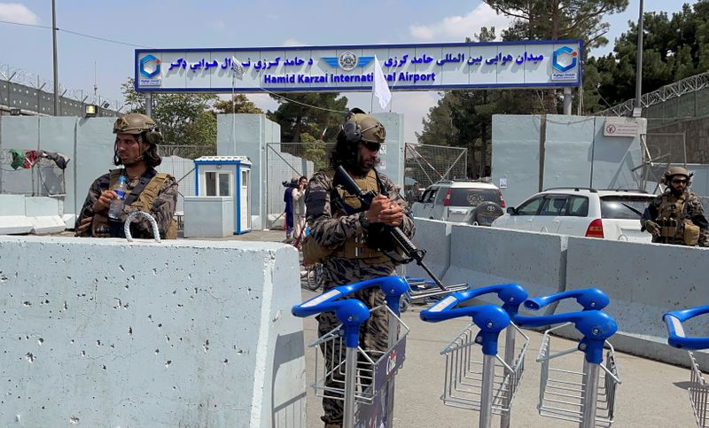 FILE PHOTO: Taliban forces stand guard at the  entrance
