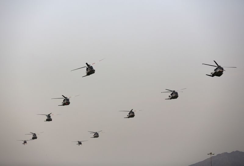 FILE PHOTO: Helicopters fly in formation during a military parade