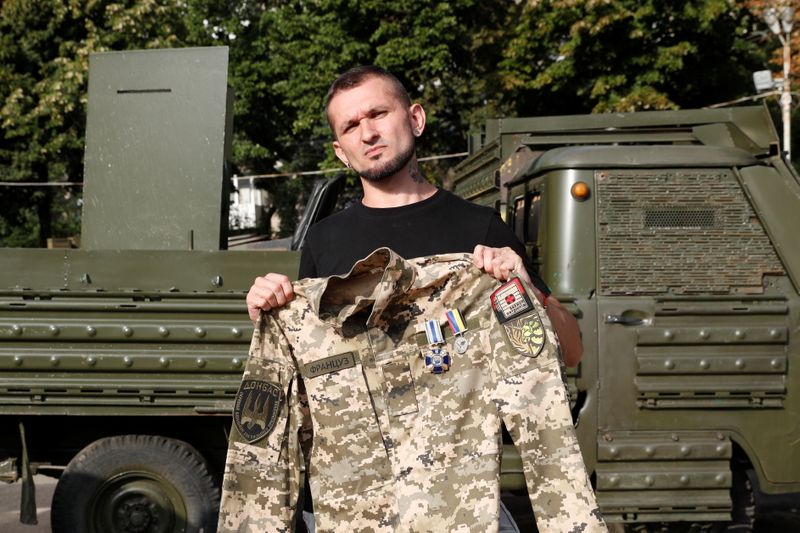 Ukrainian war veteran Viktor Pylypenko poses for a picture with