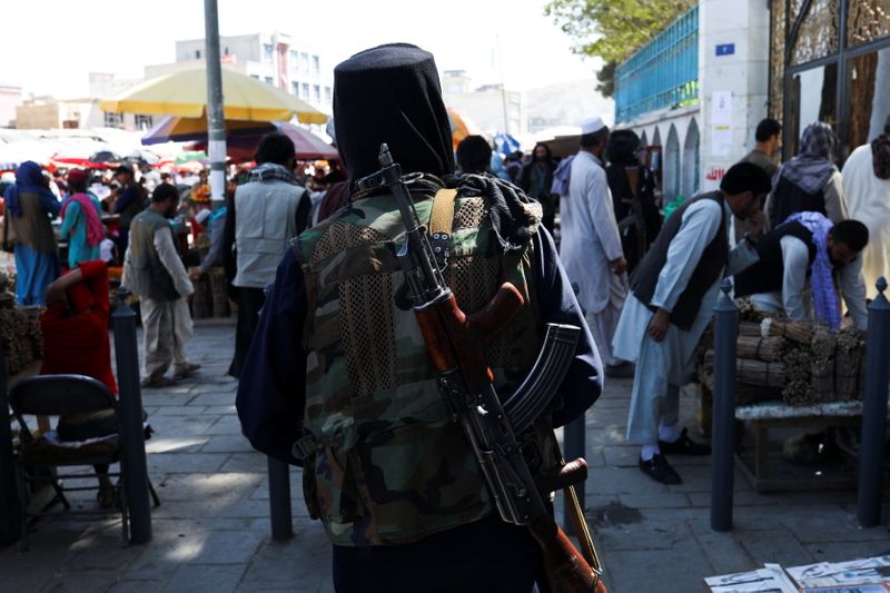 A Taliban soldier walks on a street in Kabul
