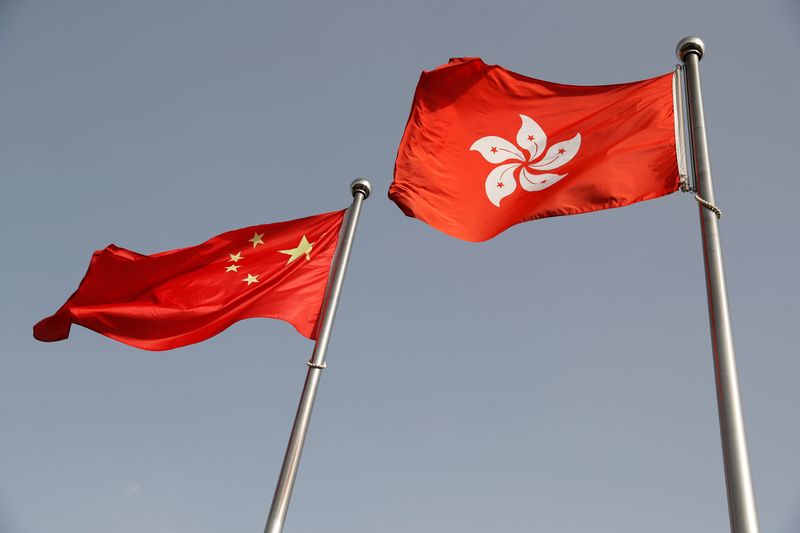 The Chinese and Hong Kong flags flutter at the office