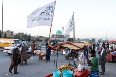 FILE PHOTO: The Taliban flags are seen on a street