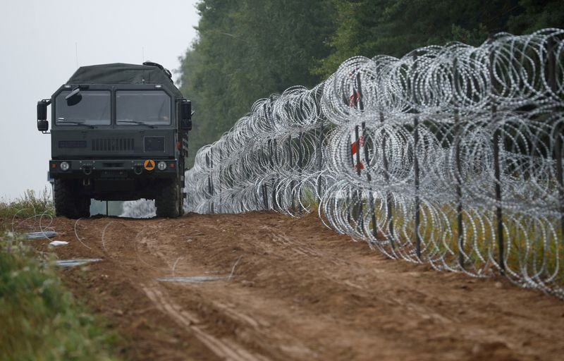 FILE PHOTO: Polish soldiers build a fence on the border