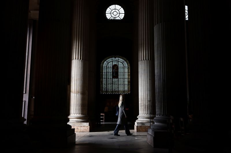 A woman walks into the Saint-Sulpice church in Paris